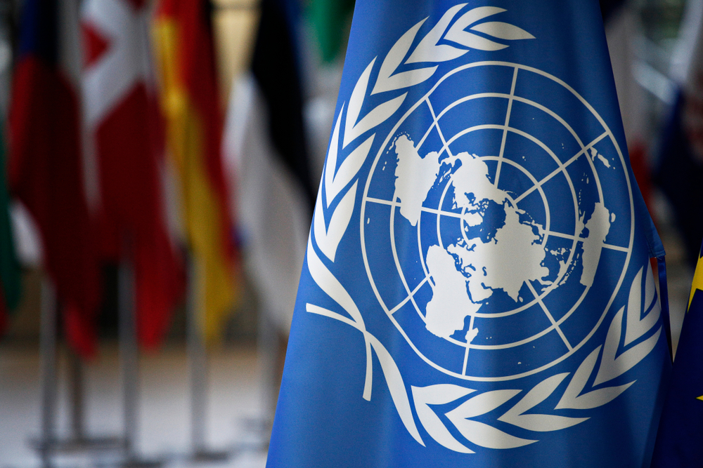 Flags of UN and EU stand in European council Building.