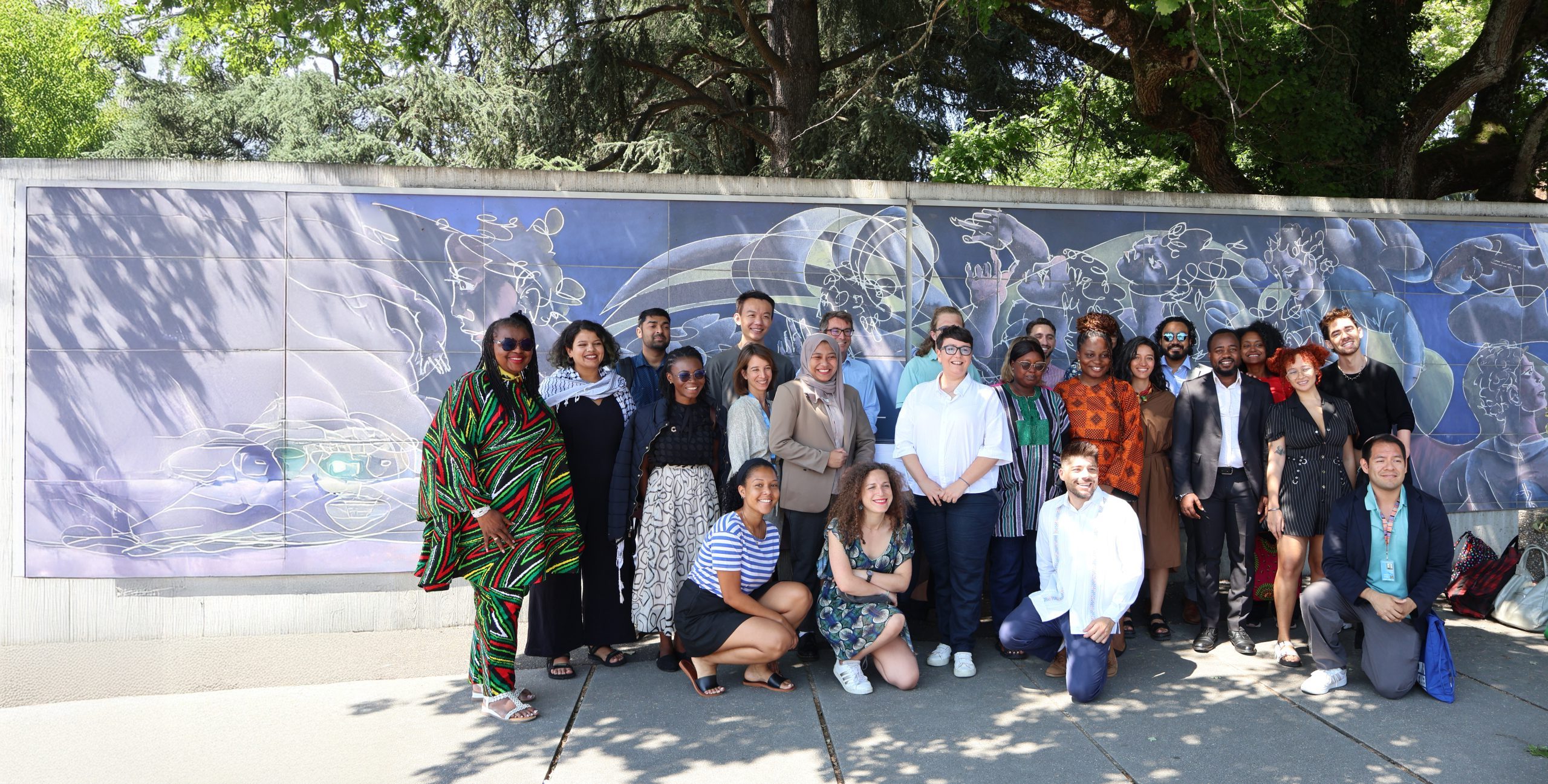 2025 Human Rights Defender Advocacy Programme (HRDAP) participants and ISHR staff in front of the UN building in Geneva ©Ben Buckland for ISHR